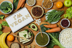 top view of colorful vegan foods and vegan notebook