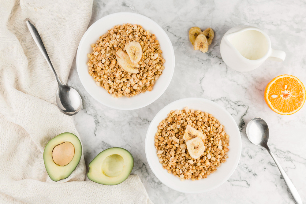 top view of oranges, avocado, and grains on table